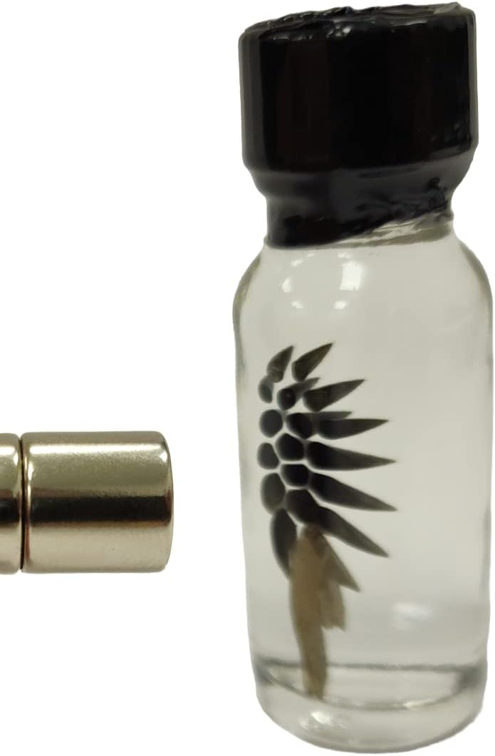 A bottle with a black magnetic substance inside.